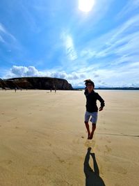 Full length of man on beach against sky