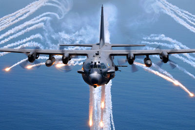 Airplane flying over sea against sky