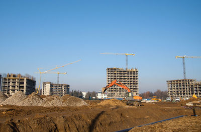Construction site against clear blue sky