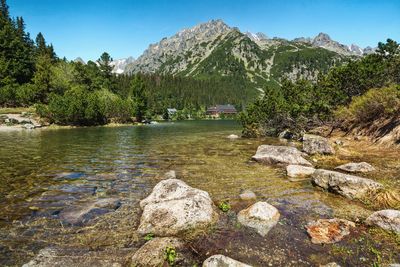 Scenic view of lake and mountains against sky