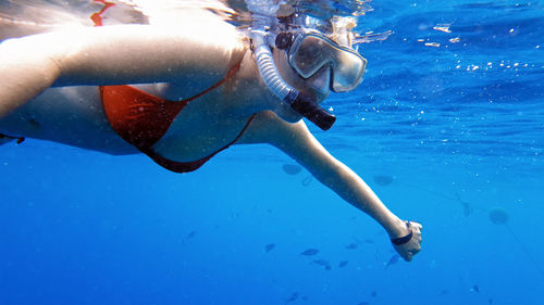 Low section of man swimming in sea