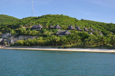 Scenic view of sea and buildings against sky