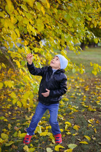 Portrait of boy standing on field