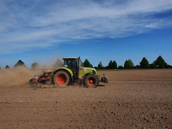 Tractor on field against sky