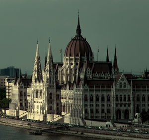 Buildings in city against clear sky