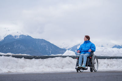 Rear view of man riding on snow