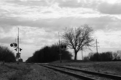 Railroad tracks by trees against sky