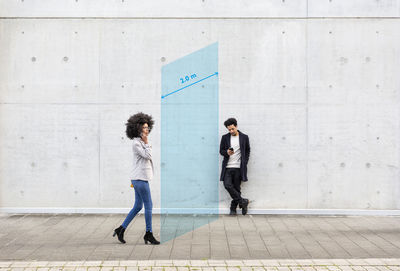 People walking in front of wall