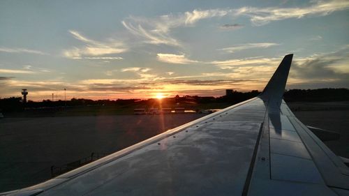 Airplane wing over clouds