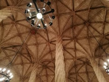 Low angle view of illuminated pendant lights hanging from ceiling