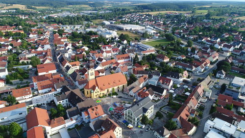 High angle view of houses in town against sky