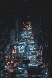 Illuminated city street and buildings at night