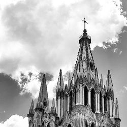 Low angle view of church against cloudy sky