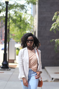 Young woman wearing sunglasses standing outdoors