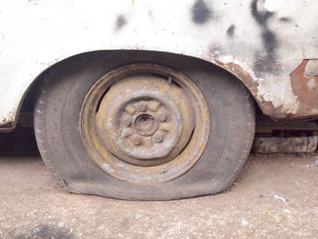 Close-up of old abandoned car on field