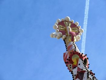 Low angle view of ferris wheel against clear blue sky