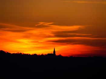 Silhouette of building at sunset