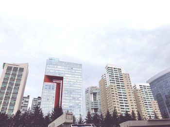 Low angle view of modern buildings against sky in city