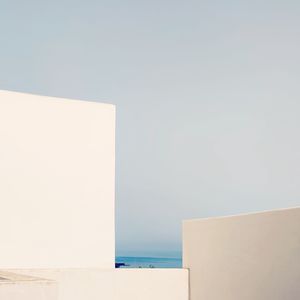 White wall by sea against sky