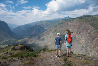 Man standing on mountain against sky