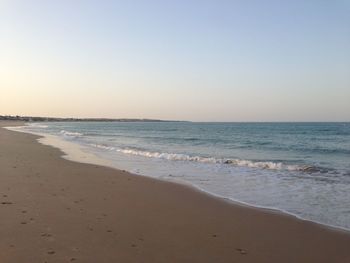 Scenic view of beach against clear sky