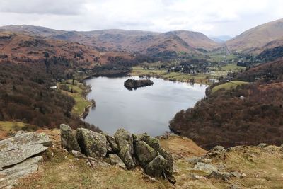 Scenic view of lake and mountains against sky