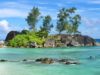 Scenic view of rocks in sea against sky