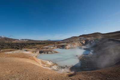 Scenic view of landscape against blue sky