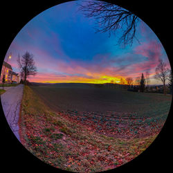 Scenic view of landscape against sky at sunset