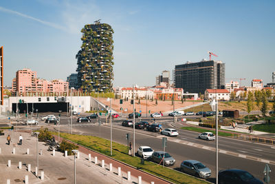 High angle view of traffic on road by buildings against sky