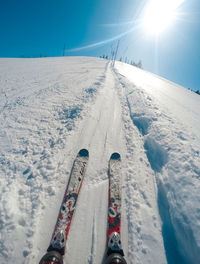 Panoramic view of people skiing on snow covered mountain against sky