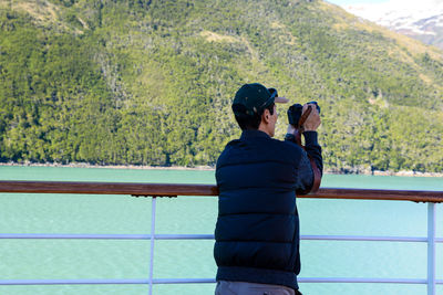 Rear view of man photographing