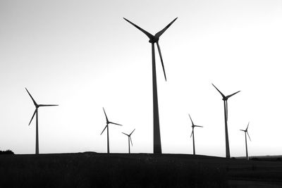 Low angle view of electricity pylon against clear sky