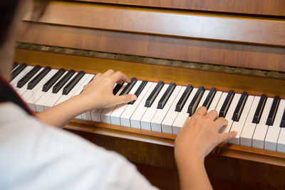 Low section of person playing piano