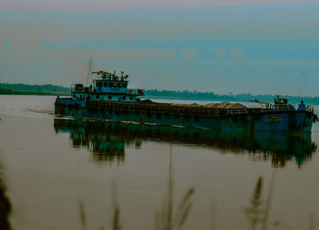 Fishing boat in sea against sky