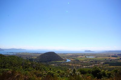 Scenic view of landscape against blue sky