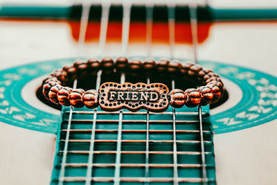 Close-up of a bracelet with a friend text on it