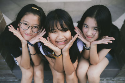 Portrait of happy smiling girls sitting outdoors