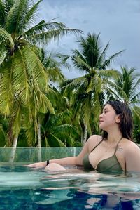 Portrait of young woman swimming in resort