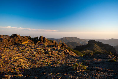 Scenic view of mountain against blue sky