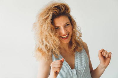 Close-up of young woman against white background