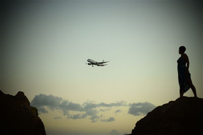 Low angle view of airplane flying against clear sky