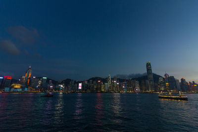 Illuminated city at waterfront