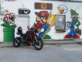 Bicycles on street against graffiti wall