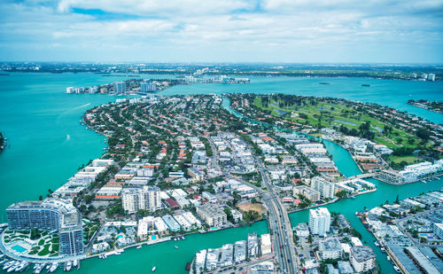 High angle view of sea and buildings against sky