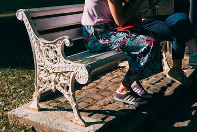Low section of woman sitting on chair