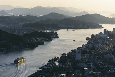 High angle view of buildings by sea against sky