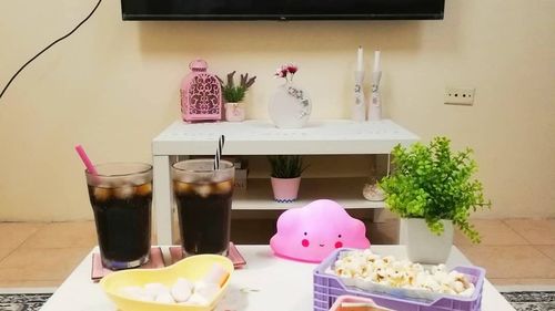 Flower vase on table against wall