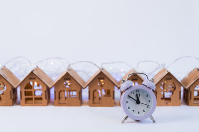 Close-up of clock at home against white background