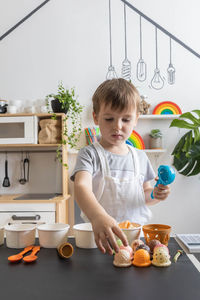 Portrait of cute boy eating food at home